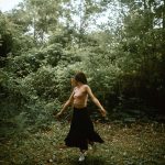 Woman spinning in a clearing at McCormick Trail located in Hamilton, Ontario