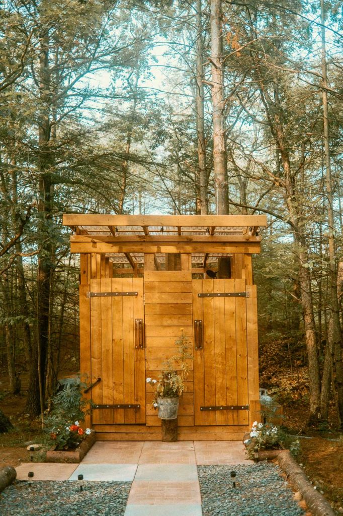 Exterior of outdoor shower and electric compost toilet at Sibo's Bell Tent Glamping Site in Verona, Ontario
