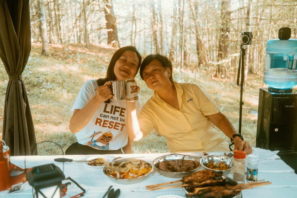Mother and Daughter enjoying picnic meal at Sibo's Bell Tent Glamping Site in Verona, Ontario