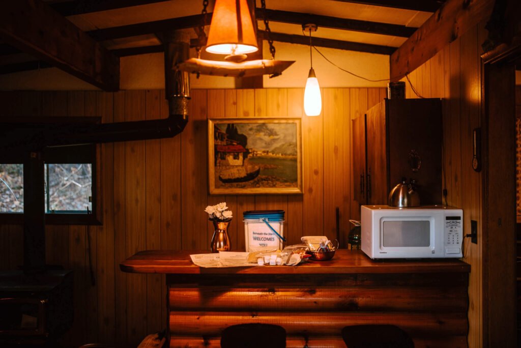Kitchenette and entryway of the Cozy Rustic, Cabin in Miden, Ontario - Hiipcamp Canada listing