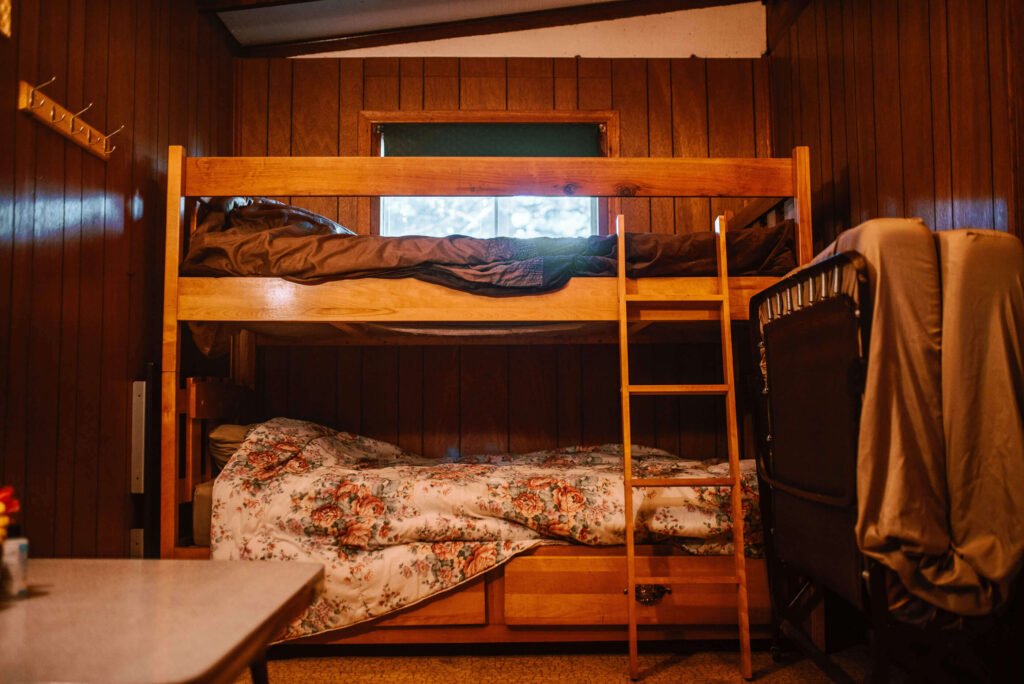 Singles bunk bed and additional futon in the bedroom of the Rustic Cozy Cabin in Minden, Ontario