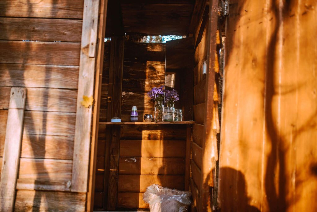 Entrance of the outhouse at the rustic cozy cabin in Minden, Ontario - Hipcamp Caanada listing